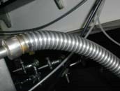 Close up photo of flexible, stainless-steel, insulated liquid cryogen transfer hose