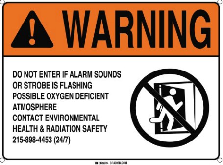 Warning sign instructing occupants to leave room in event of oxygen alarm