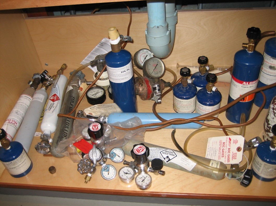 cabinet with loose lecture bottles lying on their sides