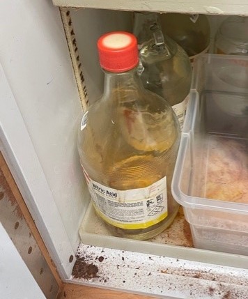 Bottle of nitric acid with damaged cap